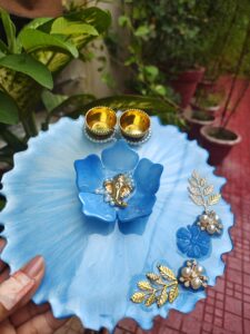 Handcrafted 8-inch sky blue resin Rakhi thali with central blue flower Ganesha idol and golden katoris