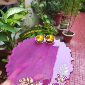 Handcrafted 8-inch orchid purple resin Rakhi thali with flower petal accents and golden katoris