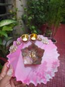 Handcrafted 8-inch pink resin Rakhi thali with central Ganesha green lotus and golden katoris