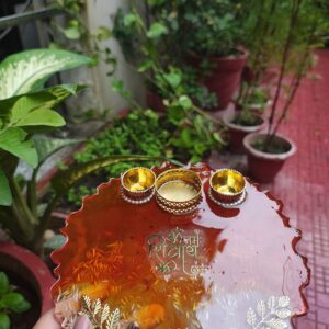 Handcrafted 8-inch red amber resin pooja thali with Om Namah Shivaya mantra, embedded rice grains, and integrated golden diya holder