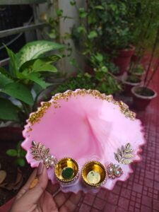 Handcrafted 8-inch bright pink resin Rakhi thali with golden katoris and gold leaf flakes