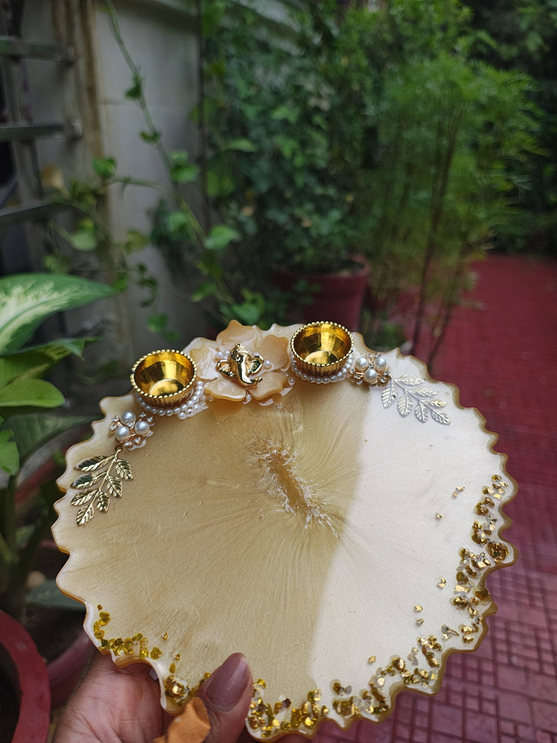 Handcrafted 8-inch cream gold resin Rakhi thali with Ganesha idol flower motif and golden katoris