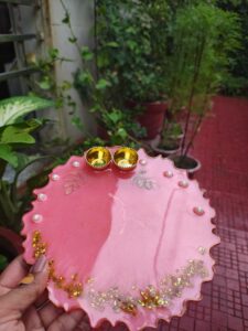 Handcrafted 8-inch coral pink resin Rakhi thali with pearl border and golden katoris