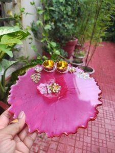Handcrafted 8-inch magenta pink resin Rakhi thali with central Ganesha lotus and golden katoris