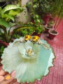Handcrafted 8-inch mint green resin Rakhi thali with central Ganesha lotus and golden katoris
